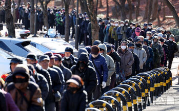 無料給食の列に並ぶ高齢者