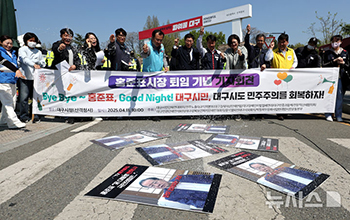 洪準杓市長のプラカードに塩をまく市民団体