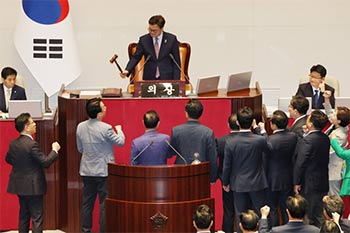 ▲1日午後、ソウル・汝矣島の国会で開かれた本会議で、崔相穆（チェ・サンモク）経済副首相兼企画財政長官弾劾訴追案を上程する禹元植（ウ・ウォンシク）国会議長に向かって抗議する与党・国民の力の議員たち。写真＝news 1